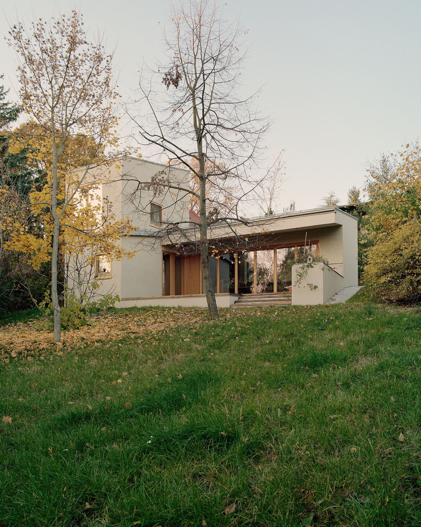 In summer, the house is shaded by linden and maple, and in winter the sun shines through it